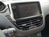 a car dashboard with a digital display and a steering wheel