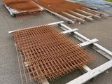 a lot of steel bars on the ground in front of a building