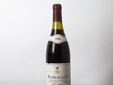 a bottle of wine sitting on a wooden table