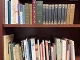 a book shelf with many books on it in a library