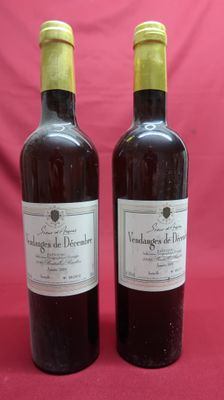 two bottles of wine sitting next to each other on a red background