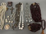 several different types of beaded necklaces and brooches on a table
