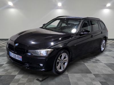une photo d'une voiture bmw noire garée dans un garage
