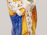 une statue de femme tenant un enfant sur une table