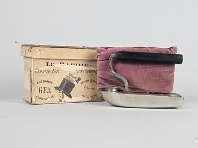a small box with a cloth on it next to a small iron