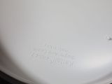 a close up of a white toilet bowl with a black lid