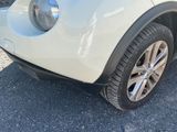 a small white car parked in a parking lot