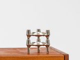a close up of a wooden cabinet with two candles on top