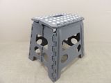 a gray stool with white polka dots on it