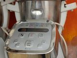 a white blender sitting on a counter next to a blender