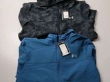 two men ' s under armour jackets, one blue and the other black