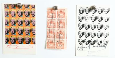three prints on the wall of a white room