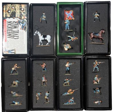 a lot of miniature figurines of people in a display case