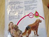 a bag of dog food on a table with a woman and a dog