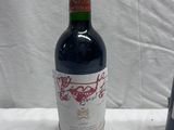 two bottles of wine sitting next to each other on a table