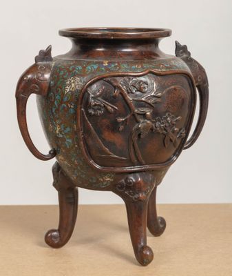a bronze vase that is on a table