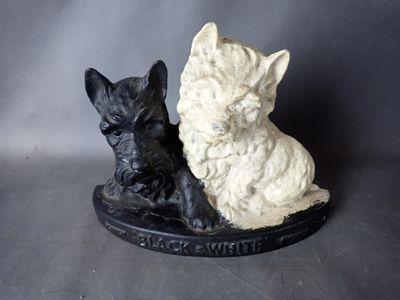 figurines de chiens noir et blanc assis côte à côte sur une table