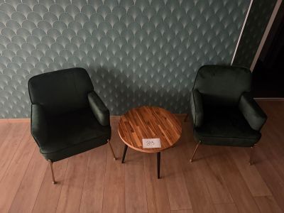 two chairs and a table in the corner of a room
