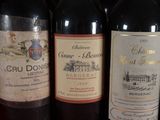 several bottles of wine are lined up on a table