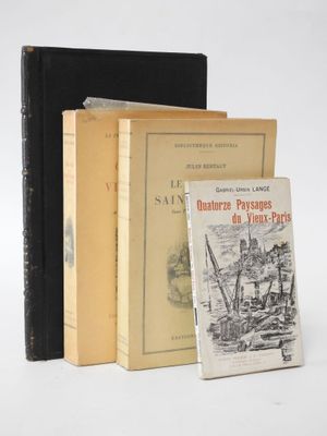 three books sitting next to each other on a white surface