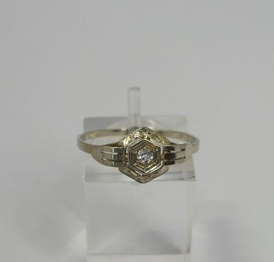 a yellow gold ring with a diamond set in the center