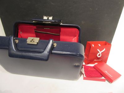 a blue suitcase and a red bag on a table