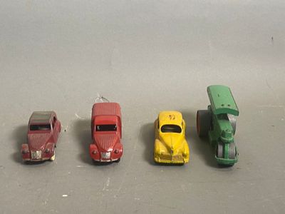 several toy cars are lined up in a row on a gray surface