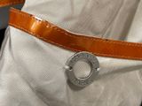 a close up of a bag with a metal buckle on it