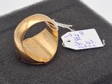 a gold ring with a tag attached to it