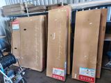 Plusieurs cartons contenant des articles divers sont empilés les uns sur les autres dans un entrepôt.