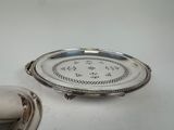 a silver plate with a silver lid and a silver plate with a silver lid