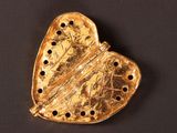 an image of a gold heart shaped locke with holes in it