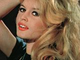 blond blond woman with long hair and bright red lipstick posing for a picture