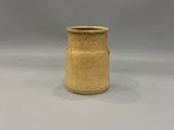 beige ceramic vase with a gold rim on a white surface