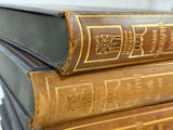 three books stacked on top of each other on a table