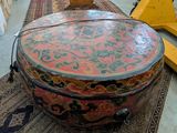 a large drum sitting on top of a rug in a room