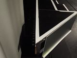 a laptop sitting on top of a desk in a dark room