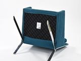 a blue chair with a laptop and a pen on it