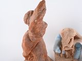 a statue of a man and a woman sitting on a bench
