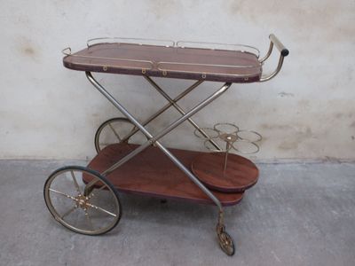 a small wooden cart with a metal handle on it