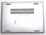 a close up of a silver laptop on a white surface