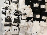 several pairs of white and black socks on display in a display case