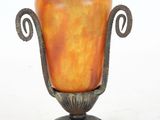 a vase that is sitting on a stand on a white surface