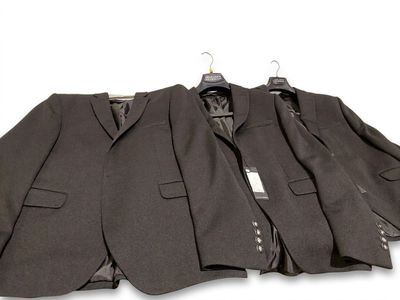 three suits are lined up on a hanger on a white background
