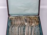 many spoons and forks in a case on the table