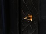 the inside of a black purse with gold hardware