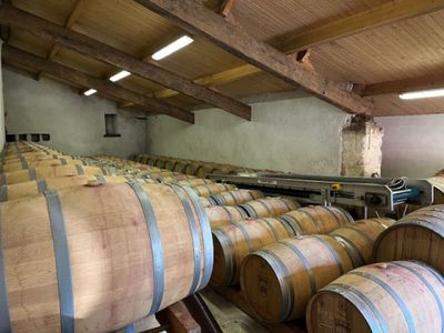 many wooden barrels lined up in a large room