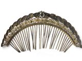 a gold comb with a flower design on it