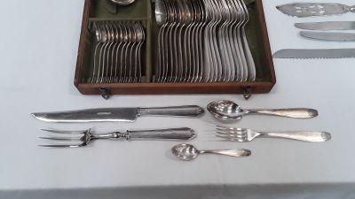 a tray with silverware on a table with a knife, fork, spoon, and spoon rest