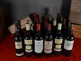 several bottles of wine are lined up on a red table cloth